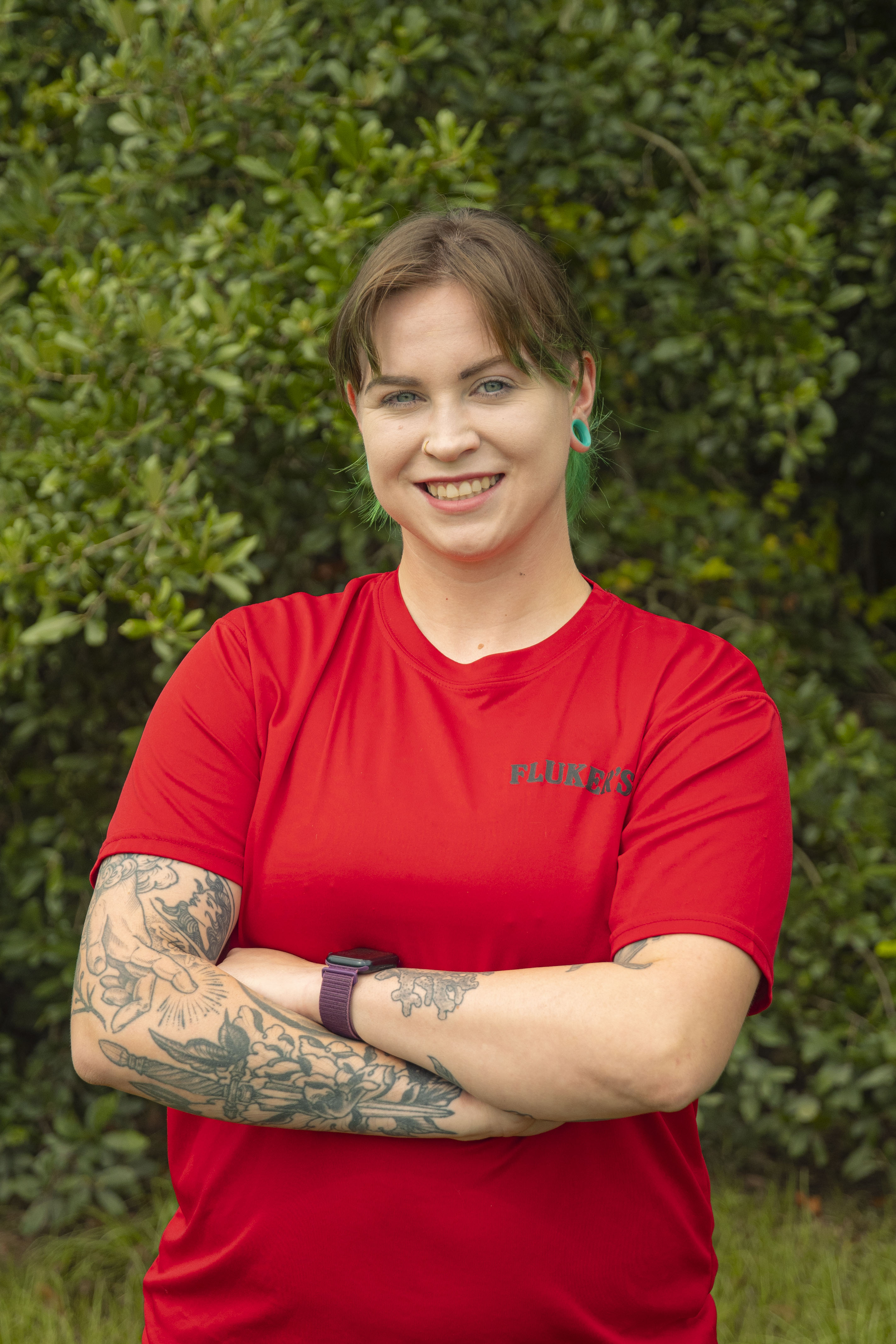 Image of Female, Victoria Vail, Fluker's Research Technician, in Red t-shirt in front of trees